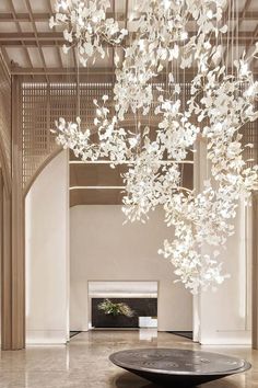 a large chandelier hanging from the ceiling in a room with marble flooring