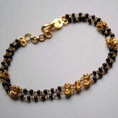 "Layered gold chain bracelet with black beads and gold balls, handcrafted with love and care, this is a very comfortable bracelet. A perfect accessory for everyday wear. Lightweight and stylish..! Available in single strand or double strand. * Length : 5.5\" to 9\" + 0.5\" extender eg : 6\" length will fit wrist size of 6\"- 6.5\" * Gold : 18k Solid Yellow Gold * Gold Weight - 4.5 gms approx for 6\" inches double strand with extender - For longer/shorter length, please ask for a quote before pla Traditional Gold Bracelets With Black Beads, Traditional Gold Beaded Bracelet With Black Beads, Traditional Gold Bracelet With Black Beads, Handmade Gold Chain Bracelet With Round Beads, Black Bracelet With Gold Beads, Gold Bracelet Jewelry With Black Beads, Gold Bracelet With Black Beads Jewelry, Traditional Gold Beaded Chain Bracelets, Elegant Gold Bracelets With Black Beads