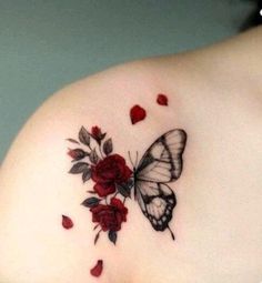 a woman's shoulder with a butterfly and roses tattoo on her left side breast