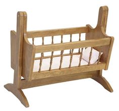 a wooden crib with a white pillow in it