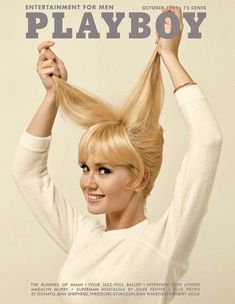 a woman is holding her hair in the air