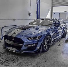 a blue sports car parked in a garage