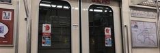 an empty subway car with two doors and signs on the wall above it that say no entry