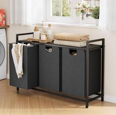 a laundry hamper sitting next to a washer and dryer