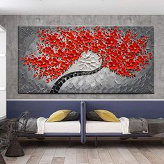 a bedroom with two beds and a painting on the wall above them that has red flowers in it