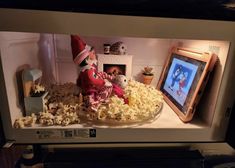 a microwave with popcorn and an elf on it