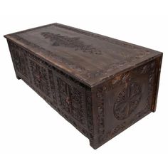 an ornate wooden box with carvings on the lid and sides is shown in this image