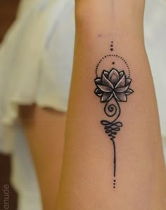 a woman's arm with a flower tattoo on the left side of her body