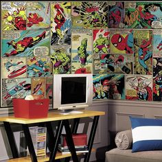 a living room filled with furniture next to a wall covered in comic book covers on the walls