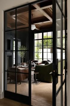 an open glass door leading into a living room