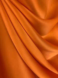 Orange Pure Mulberry Silk Fabric Width 44 inch (112 cm), Industry Thickness : 19 m/m (Momme) Content: 100% Pure Silk Silk Charmeuse Fabric possesses not only the finest aesthetics, but retains the fluid sophistication most sought after in silk fabrics. At the top of its class, Charmeuse Fabric is a satin weave that allows this fabric to retain a soft feel and supple drape that most high-end designers crave, this fabric has many applications as it is composed of both a shiny face on one side and Shiny Face, Wedding Brand, Silk Texture, Charmeuse Fabric, Mulberry Silk Fabric, Orange Texture, Orange Satin, Silk Fabrics