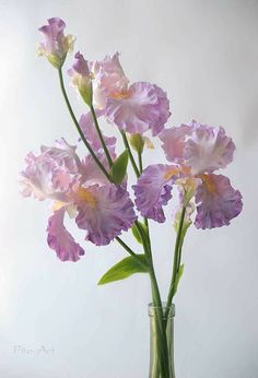 a vase filled with purple flowers on top of a table