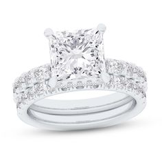 a princess cut diamond engagement ring set with matching bands on the band and side stones