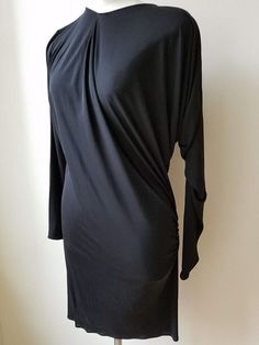 Description Size 40   This is a lovely dress by Lanvin ALBER ELBAZ in "Black"100% Viscose.   This long sleeve dress has an asymmetrical design. COLLECTIBLE !! It is marked a French size 4, a US size 10, and measures approximately: 14" shoulder to shoulder, up to 46" bust, 38" waist, 35" hips, and 38" long from top of shoulder to the hem.    The dress is in excellent condition. Long Sleeve Stretch Dress For Evening, Formal Fitted Long Sleeve Silk Dress, Silk Evening Dress With Long Sleeves, Silk Long Sleeve Evening Dress, Long Sleeve Midi Dress With Draped Sleeves For Party, Elegant Fitted Silk Long Sleeve Dress, Elegant Long Sleeve Mini Dress For Dinner, Long Sleeve Ruched Midi Dress For Dinner, Elegant Long Sleeve Ruched Dress For Night Out