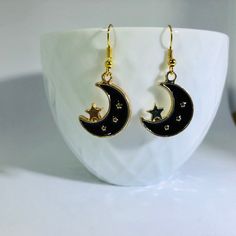 "Gold Plated Enameled Moon & Star Charm Earrings Material: Zinc Based Alloy (Lead and Nickel Safe) Size: 24mm x17mm (1\" x 5/8\") Color: Gold Plated/Black Nickel free ear-wire  Join my facebook group to see when new items are available- https://www.facebook.com/radcrafty Instagram- https://www.instagram.com/radberry1/" Star Earrings Dangle, Moon Gold, Black And White Stars, Kawaii Earrings, Earrings Star, Moon And Star Earrings, Crescent Moon Earrings, Black Moon, Gold Moon