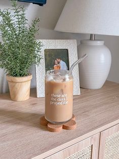 there is a drink on the table with a straw in it and a photo next to it