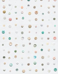 a white wall covered in lots of different colored buttons