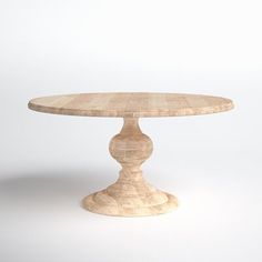 a small round wooden table sitting on top of a white floor