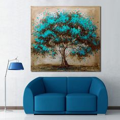 a living room with a blue couch and painting on the wall