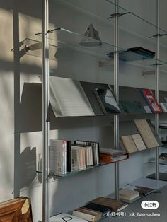 a bookshelf filled with lots of books next to a wall mounted shelf full of books