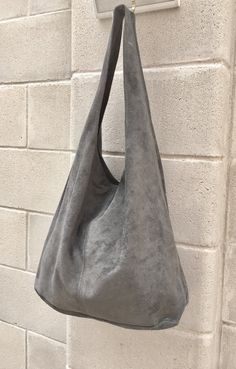 Suede slouch bag with ZIPPER. LARGE tote bag in gray. Natural genuine SUEDE bag. Soft leather HOBO bag in GRAY. Large enough to fit most laptops, tanlets, books etc. Comfortable to carry due to the wide soft suede strap. Laptop or book bag in genuine suede leather. NOT LINED. The bag is closed by a zipper at the top Width : 42cm - 16,5 in Height at the center: 34 cm - 13, 5 inc Total height : 65,5 cm - 26 inch This bag in different colors and other leather Bags by Good Times Barcelona: https://w Suede Hobo Bag With Removable Pouch And Double Handle, Double Handle Suede Bucket Bag With Soft Leather, Suede Lined Hobo Tote Bag For Shopping, Suede Hobo Bag With Double Leather Handles, Suede Bucket Bag For Shopping, Soft Suede Bucket Bag For Shopping, Soft Suede Leather Bucket Bag For Shopping, Suede Soft Leather Bucket Bag For Shopping, Suede Hobo Bag With Removable Pouch For Everyday