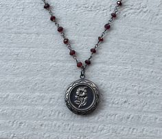 This necklace is handmade with a 3mm genuine garnet rosary chain and a flower locket pendant. The locket opens up so you can place a photo inside.  This necklace is hypoallergenic. (Cadium free, lead free, and nickel safe) Garnet is an energizing stone that promotes passion and love.  The necklace comes in a ribbon-wrapped box, ready to be gifted. If you would like to leave a note, you can do so during checkout. Necklaces Ideas, Handmade Pendant Necklace, Mazzy Star, Crystal Necklaces, Dope Jewelry, Rosary Chain, Funky Jewelry, Jewelry Lookbook, Handmade Pendant