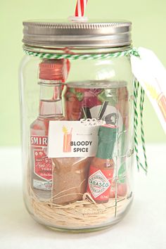 a glass jar filled with spices on top of a table