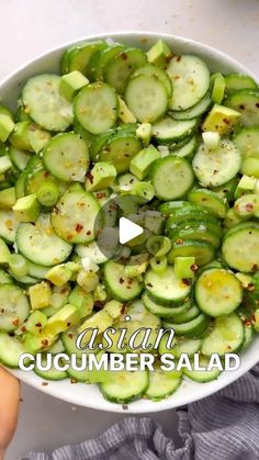 cucumber salad with seasoning in a white bowl