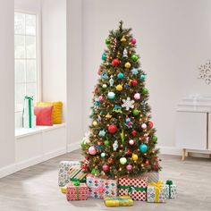 a decorated christmas tree with presents under it