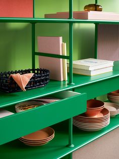 green shelves with plates and books on them