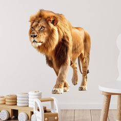 a large lion standing on top of a wooden table next to a white chair and wall