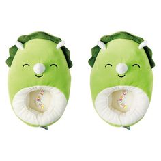 a green stuffed animal with its mouth open and eyes closed, sitting next to each other