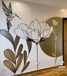 a wall with flowers and a bird painted on it