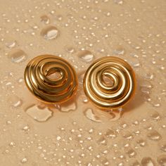 These bold spiral earrings feature a unique circular design that draws attention effortlessly. Crafted in a golden finish, the earrings provide a statement piece perfect for casual days or upscale nights. With their lightweight feel and artistic vibe, they’re the ideal accessory to enhance any outfit with a dash of sophistication. The round silhouette and distinct swirl design create a chic and modern look.Composition:Ethically sourced Stainless Steel-Plated 18k Gold.Water, Sweat, and Heat Resis Trendy Spiral Earrings For Party, Gold Swirl Metal Earrings, Spiral Gold-plated Earrings, Gold Swirl Earrings For Pierced Ears, Gold Plated Spiral Earrings, Gold Round Earrings, Artistic Vibe, Diamond Hair, Gold Water