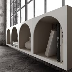 the bookshelf is made out of concrete and has two shelves on each side