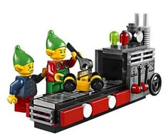 two legos are standing in front of a toy train with an oven on it