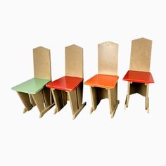 three chairs made out of cardboard sitting next to each other