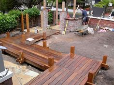 a man is working on a wooden deck