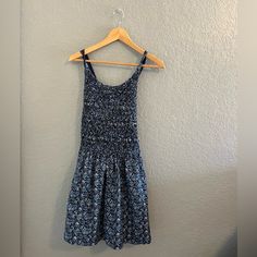 Nwt Free People | Petunia Cotton Mini Dress In Blue Floral Smocked Overall Style, Size S So Sweet In An Apron-Style Silhouette, This Essential Mini Dress Features A Textured Top Piecing With Cross-Straps At Back For Added Dimension. Beautiful Blue Cottage Core Vibes With Little White Flower Print. Features: Button Closure At Straps Side Pockets Scoop Neckline Care/Import Machine Wash Cold Inside Out 100% Cotton Measurements For Size Small Bust: 30 In Length: 30.5 In Size: Women's Small Color: Bl Casual Smocked Ruched Stretch Dress, Casual Stretch Smocked Dress With Ruched Detail, Casual Stretch Smocked Ruched Dress, Casual Ruched Smocked Stretch Dress, Casual Smocked Stretch Dress, Casual Blue Smocked Beach Dress, Blue Mini Smocked Dress For Daywear, Blue Cotton Dress With Gathered Waist, Blue Mini Sundress With Smocked Bodice