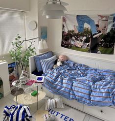 a bed room with a neatly made bed and a poster on the wall above it