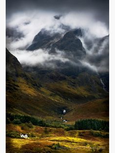 the mountains are covered in fog and clouds