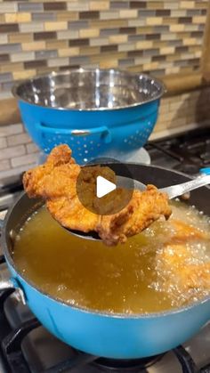 a frying pan filled with food on top of a stove next to a blue bowl