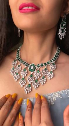 Add a touch of glamour and sophistication with this high quality necklace set in beautiful emerald gree. stones. The stones in this set bling and look close to the real thing. This set is sure to make heads turn!  It features an adjustable necklace and a pair of earrings. It can be paired perfectly with both ethnic and western outfits.  In case of any queries, please feel free to reach out. Happy shopping! Dazzling Green Emerald Necklace For Formal Occasions, Cubic Zirconia Emerald Necklace For Wedding, Green Sparkling Stones Jewelry Sets For Party, Hand Set Crystal Emerald Necklace For Wedding, Wedding Emerald Crystal Necklace Hand Set, Fine Jewelry Emerald Necklace With 17 Jewels For Wedding, Silver Emerald Jewelry Sets For Wedding, Dazzling Green Diamond Necklaces, Dazzling Hand Set Emerald Necklace For Wedding