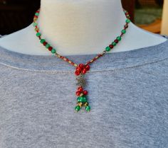 Handmade artisan Christmas beaded necklace gift for her.  This beautiful beaded Christmas necklace is loaded with different antique brass beads, a beautiful antique brass snowflake for the focal point, red and green metallic 11/0 miyuki seed beads, green and red czech glass beads in different shapes.  Made on very strong beading wire.  Has a lobster clasp.  If you need an extender chain just message me.  I usually ship in a brown jewelry box so if you want a Christmas box just let me know.  Everything is nickel free.  This statement necklace makes great Christmas gifts for her. To visit my Etsy store click here: https://www.etsy.com/shop/BNJewelryAndArtwork Here Are A Few Details about my handmade jewelry: * I use very strong bead stringing wire for my necklaces * No two are alike * I use Bohemian Jewelry For Christmas Holiday, Bohemian Jewelry For Christmas, Bohemian Christmas Festive Jewelry, Bohemian Christmas Holiday Jewelry, Bohemian Christmas Jewelry With Beads, Bohemian Christmas Jewelry, Holiday Handmade Green Jewelry, Adjustable Festive Necklaces For Christmas, Adjustable Christmas Festive Necklaces