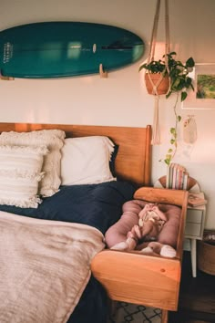 a bed with a surfboard hanging above it