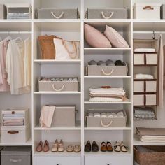 an organized closet with white shelving and linen bins, baskets, and shoes