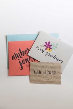 three cards with different designs on them sitting next to each other