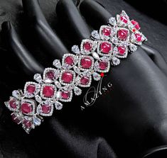 Silver Swarovski Glass Filled Ruby Bracelet |Cubic Zirconia Bracelet |Contemporary Bracelet |925 Silver Bracelet |Bridal Jewelery| 18K Plated | Statement Jewelery Material : Silver Gemstone: Swarovski Cubic Zirconia Stones, Glass Filled Rubies Stone colour: White Primary colour: Gold Closure : Box Lock Bracelet length: 165mm Bracelet width : 10mm Silver Intricate, hand crafted, Pure Silver Swarovski Bracelet, studded with high quality Cubic Zirconia Stones , made in 92.5 silver with 18ct dual go Luxury Cubic Zirconia Bracelets With Stones, Luxury Diamond Bracelets With Stones, Dazzling Bracelets With Elegant Design For Formal Occasions, Luxury Sparkling Stones Bangle For Formal Occasions, Dazzling Elegant Bracelets As Gift, Red Diamond Bracelet For Wedding, Crystal Gemstone Bracelets For Wedding, Elegant Diamond Bracelets For Reception, Red Diamond Wedding Bracelet