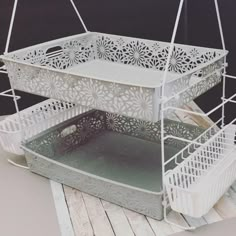 two white baskets sitting on top of each other