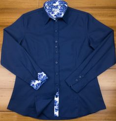 Chic and smart too! This stunning navy-blue cotton twill shirt is contrasted with a tremendous delft blue floral design to make this a great everyday wardrobe staple. Darted front and back provide a more tailored and figure-hugging look. DETAILS Material (100% micro twill cotton) Turn back Cuffs Contrasting color and cuffs Anti-gape Button placket Care (Machine wash at 30°) Country of Origin (Thailand) Blue Cotton Office Shirt, Blue Cotton Shirt For Office Wear, Blue Fitted Cotton Dress Shirt, Fitted Blue Cotton Dress Shirt, Fitted Blue Collared Shirt, Blue Fitted Shirt With Fold Down Collar, Blue Dress Shirt For Office Wear In Spring, Fitted Blue Shirt With Fold Down Collar, Blue Dress Shirt For Spring Office Wear